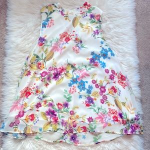 Cream colored floral sleeveless top. Purchased from a Boutique